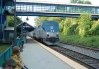 Virginia railway train car passing under a bridge