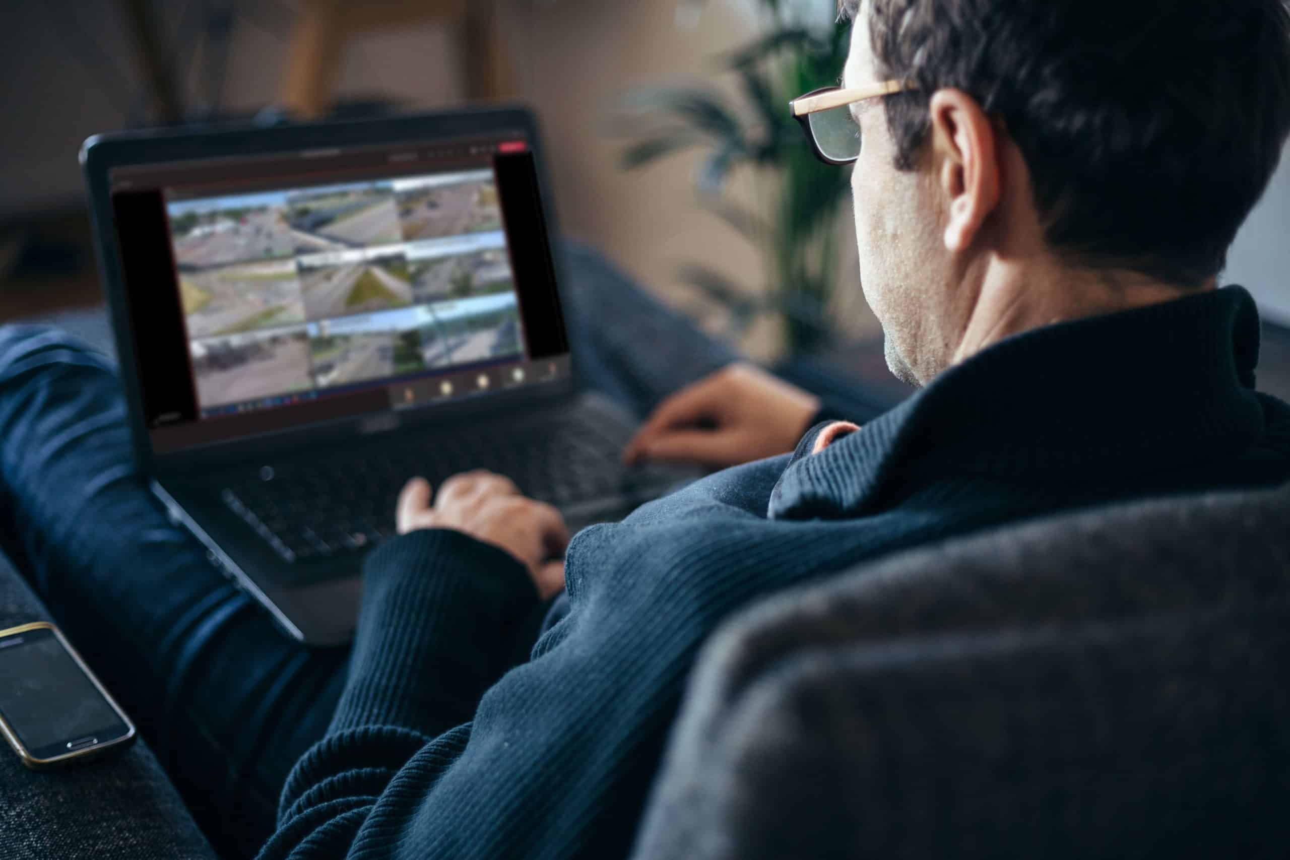 Man on laptop looking at Virtual Traffic Management Center