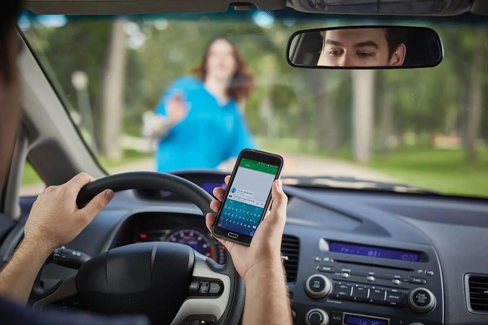 Driver texting while driving and unaware of pedestrian safety