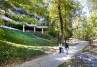 A family walks the trail that is behind an office building.