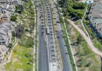 An aerial view of a bus station in the middle of the roadway