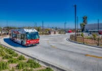 A Rapid bus station comes around the bend of the road