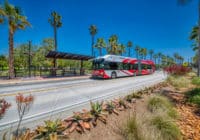 A rapid bus stops at a bus stop.