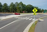 Two lane roundabout with pedestrian crosswalk and pedestrian yield sign