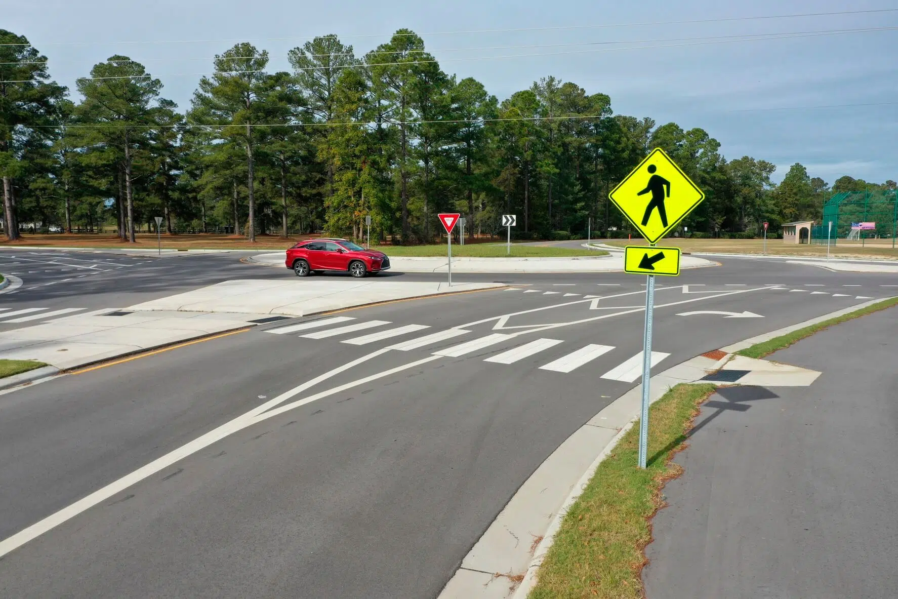 Two lane roundabout with pedestrian crosswalk and pedestrian yield sign