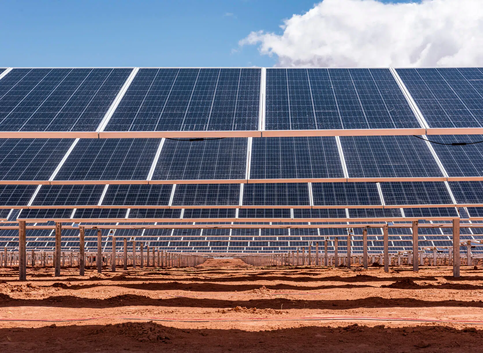 large solar panel field in desert for utility scale solar energy production