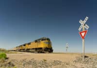 Railroad crossing sign as a train crosses a track