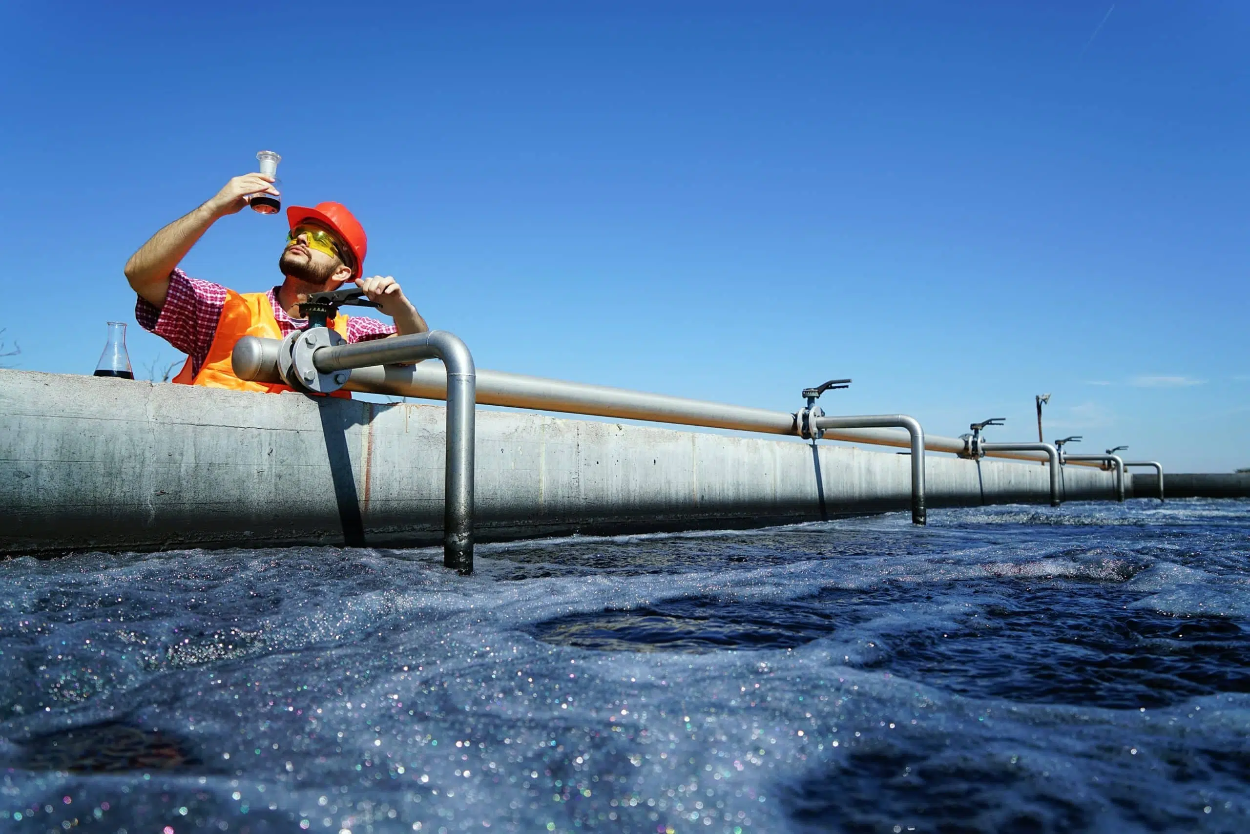 A man testing PFAS levels in a pipe