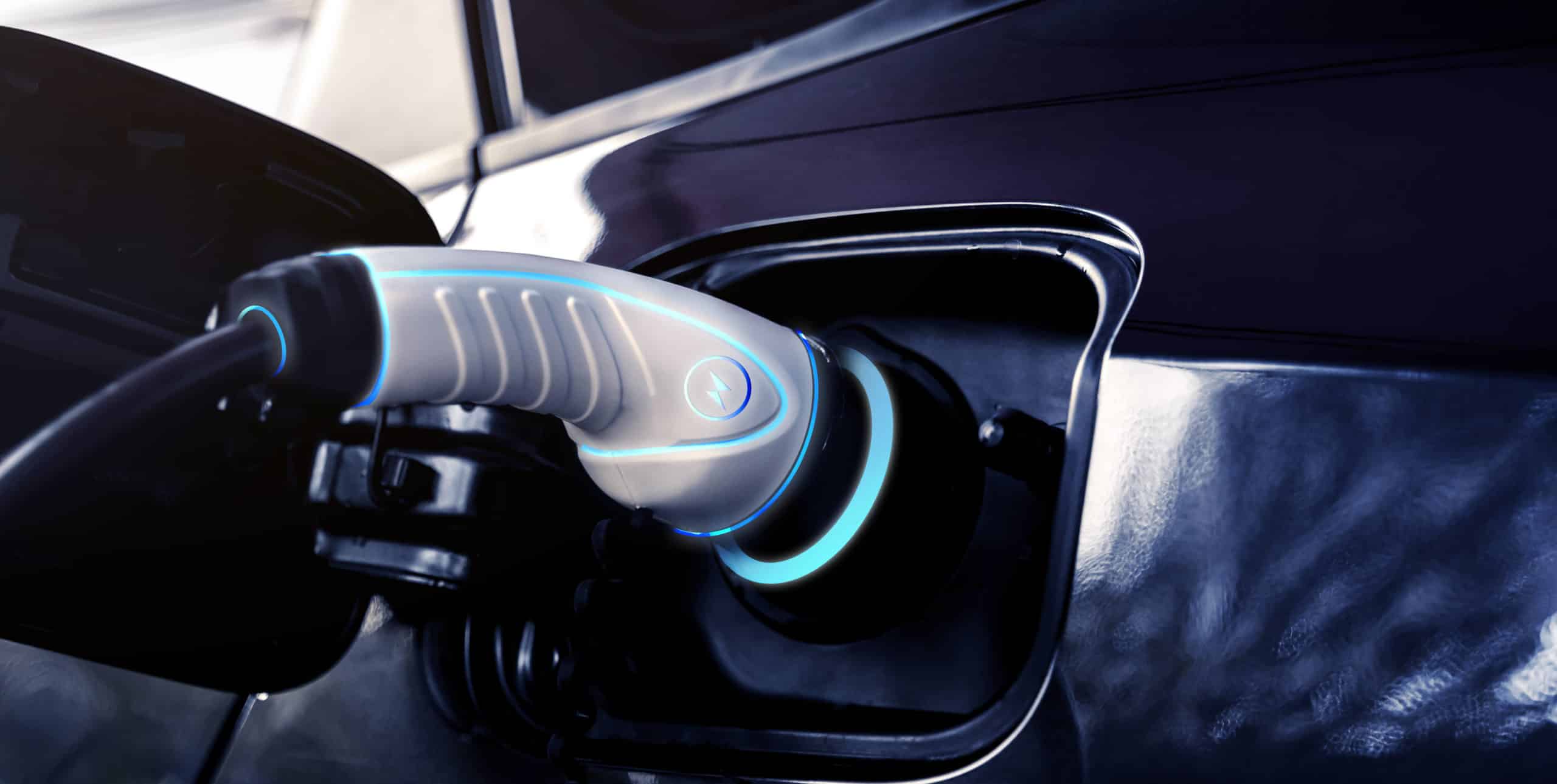 Close up view of a EV charging plug in a car to charge