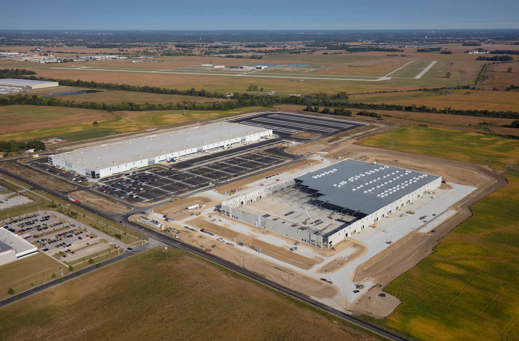 Aerial view of a completed and under construction industrial warehouse facility